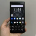 A close-up image of the BlackBerry Keyone smartphone, displaying the BlackBerry logo on the screen and the physical keyboard below.