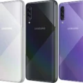 A sleek Samsung Galaxy A50s smartphone lying on a white surface with a vibrant display.